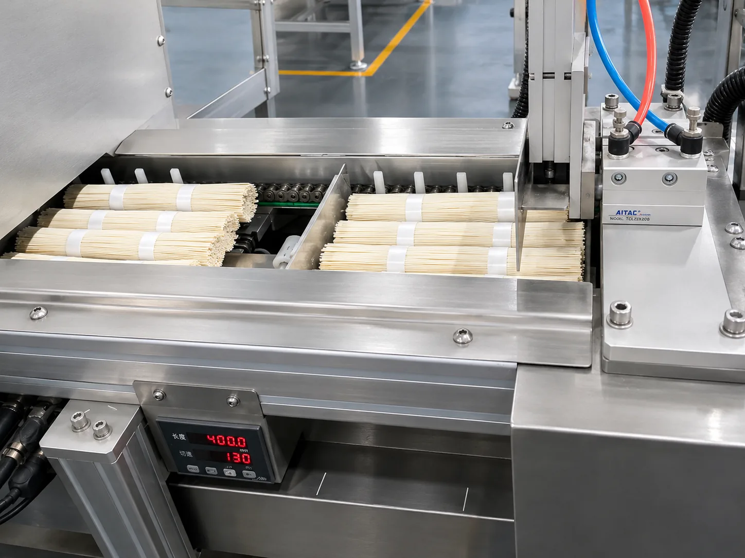 Packaged noodles leaving the packing machine